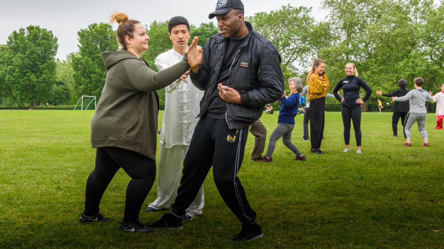 students doing Taiji in a park