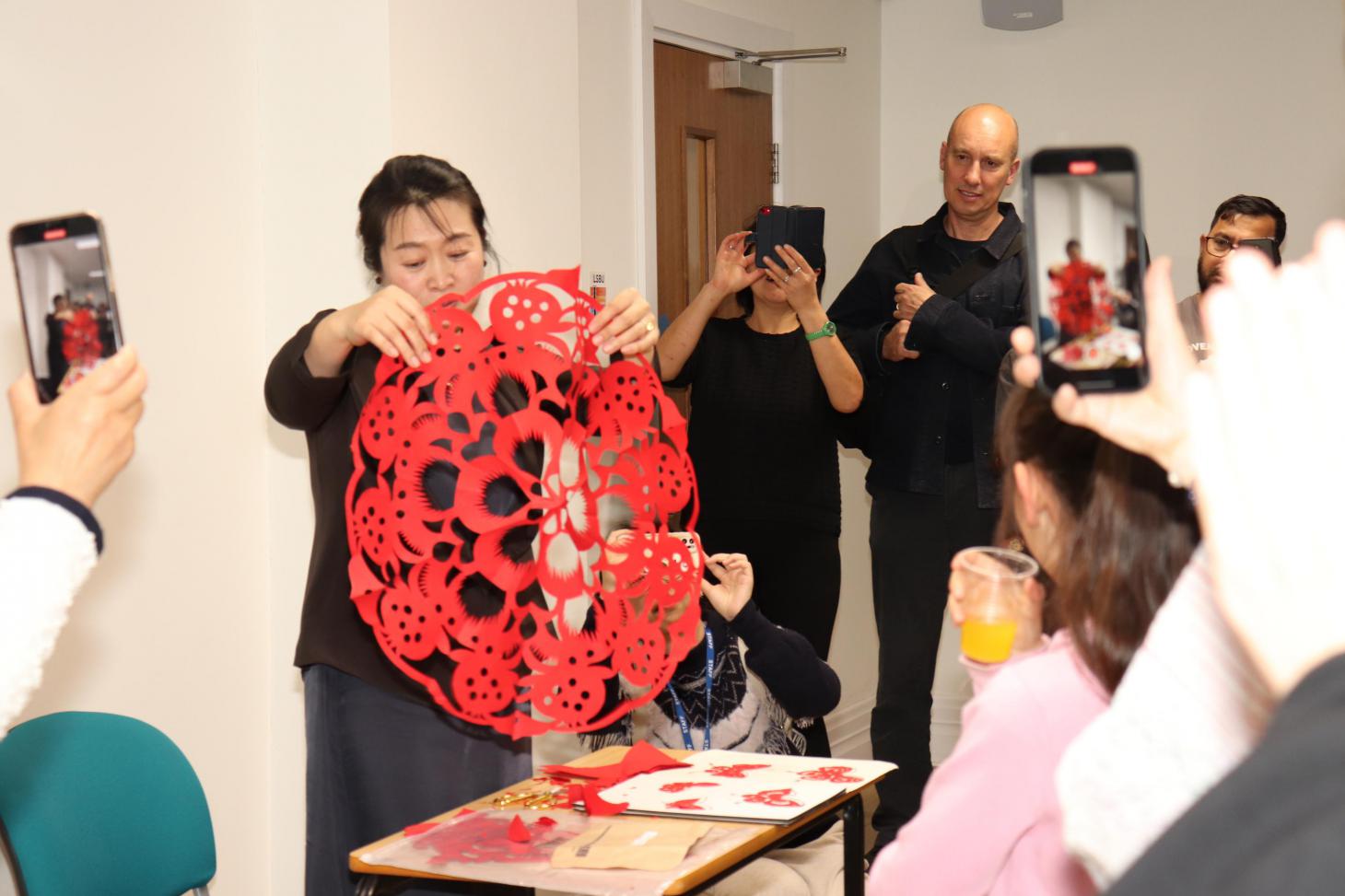 Professor Yan demonstrating papercutting